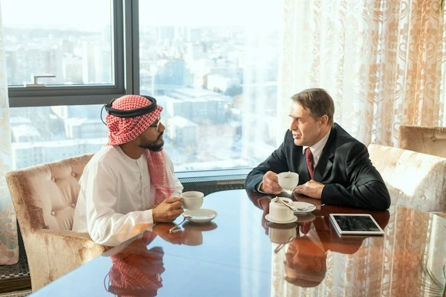 Man presenting notes on a flip chart to seated colleagues